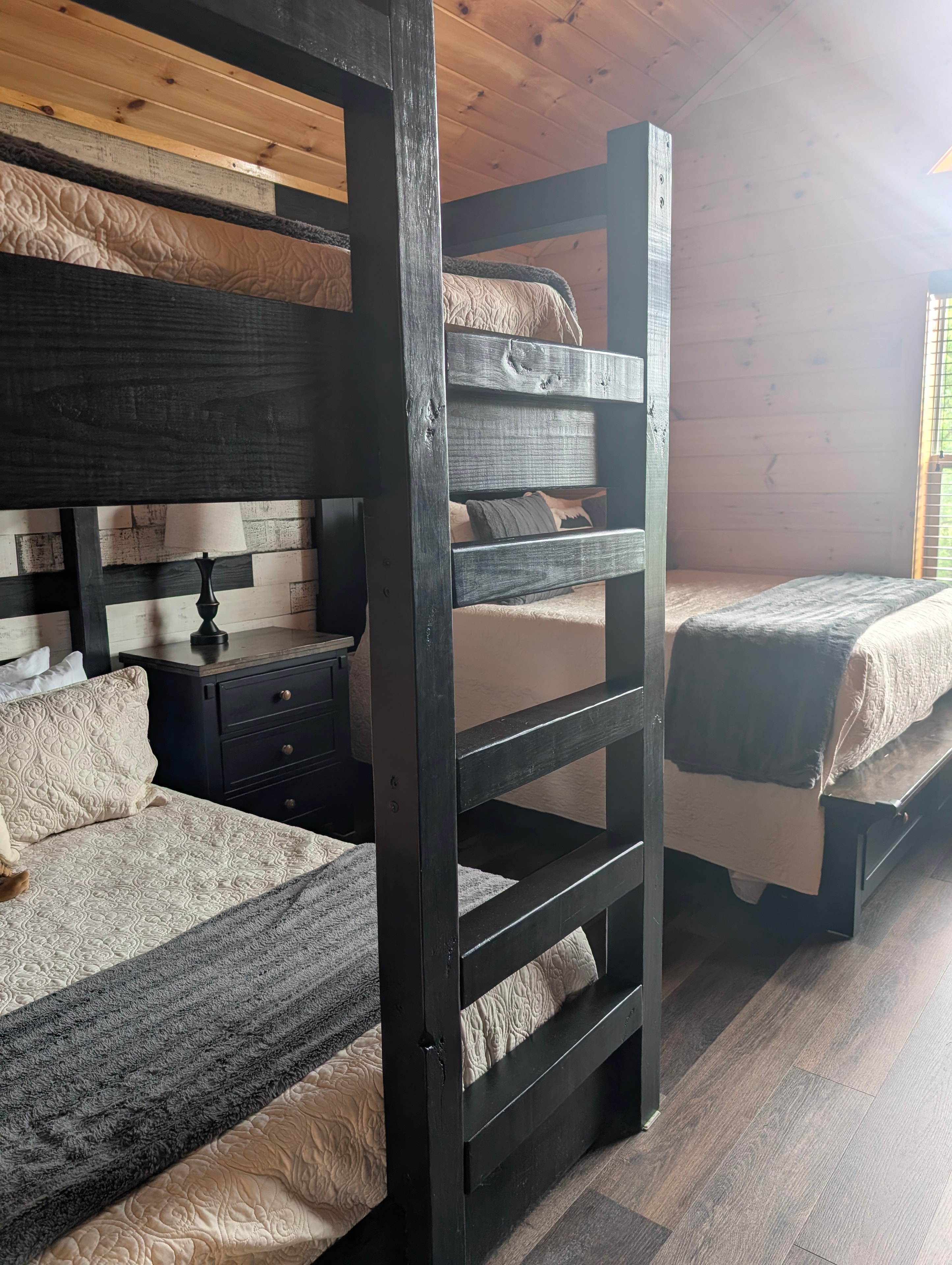 Bunk room with black bunk beds and twin beds