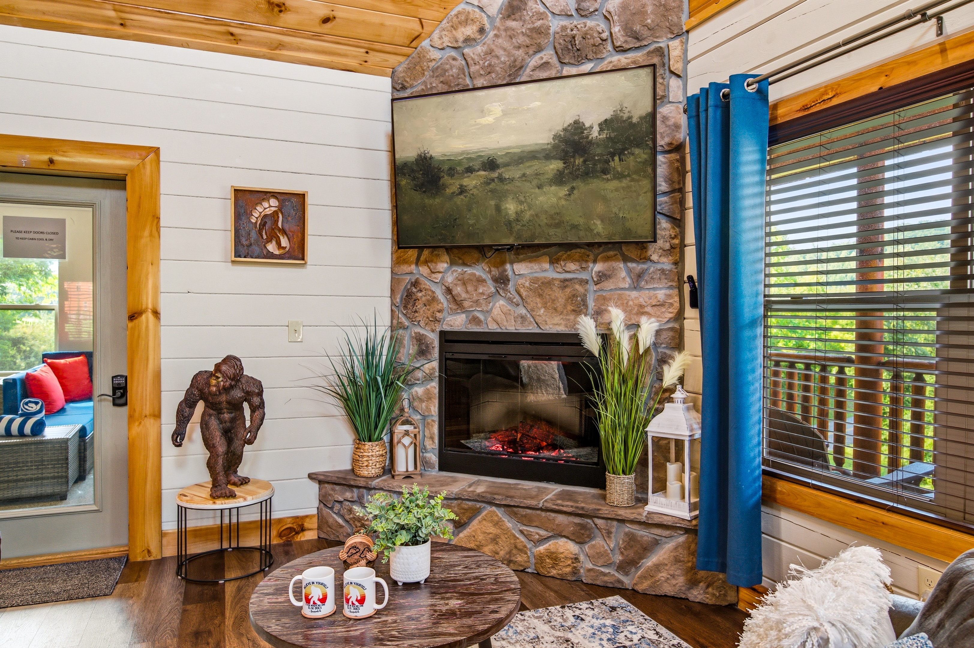 Living room and kitchen corner with blue curtains and couch