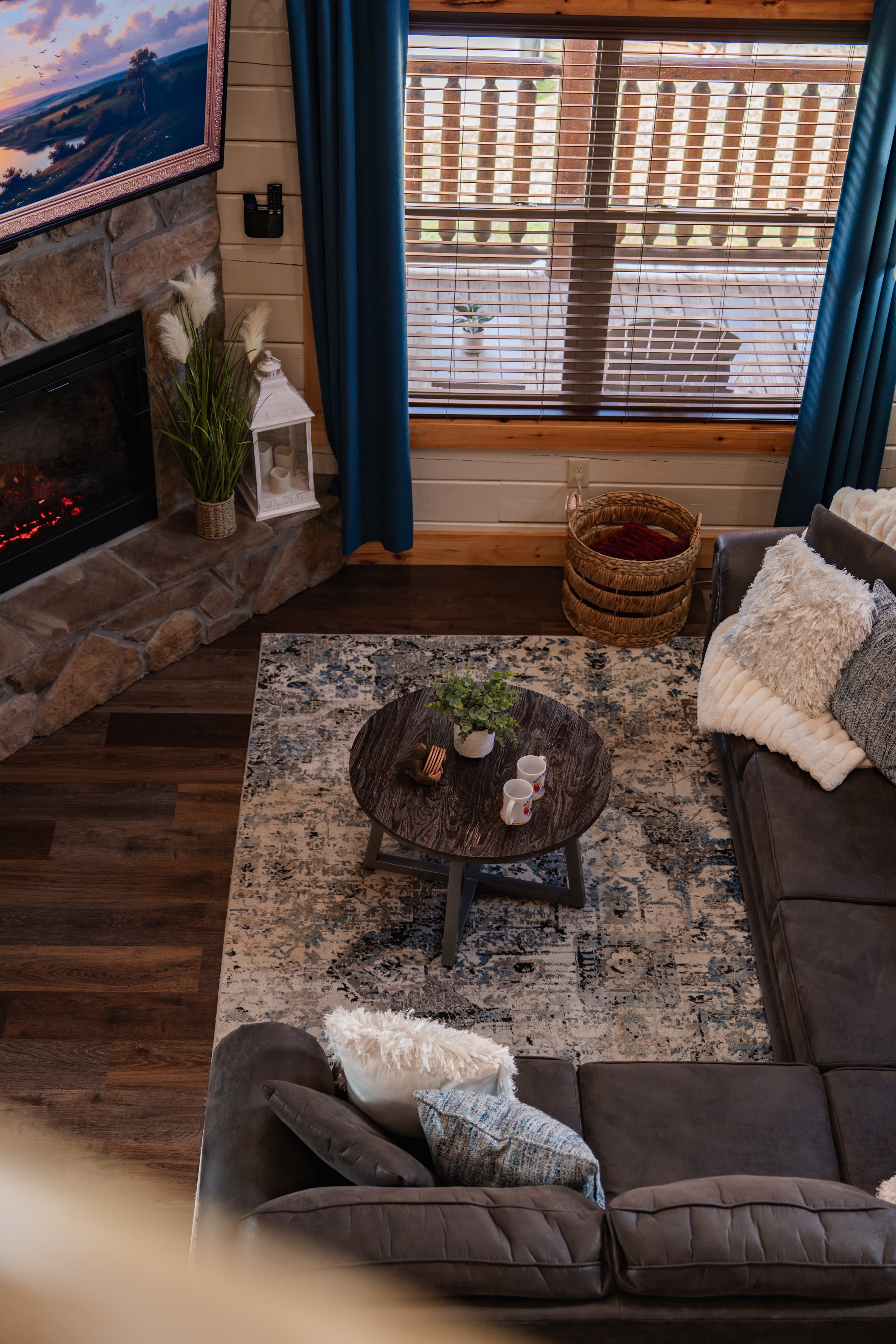 Living room with stone fireplace, Sasquatch statue and coffee table