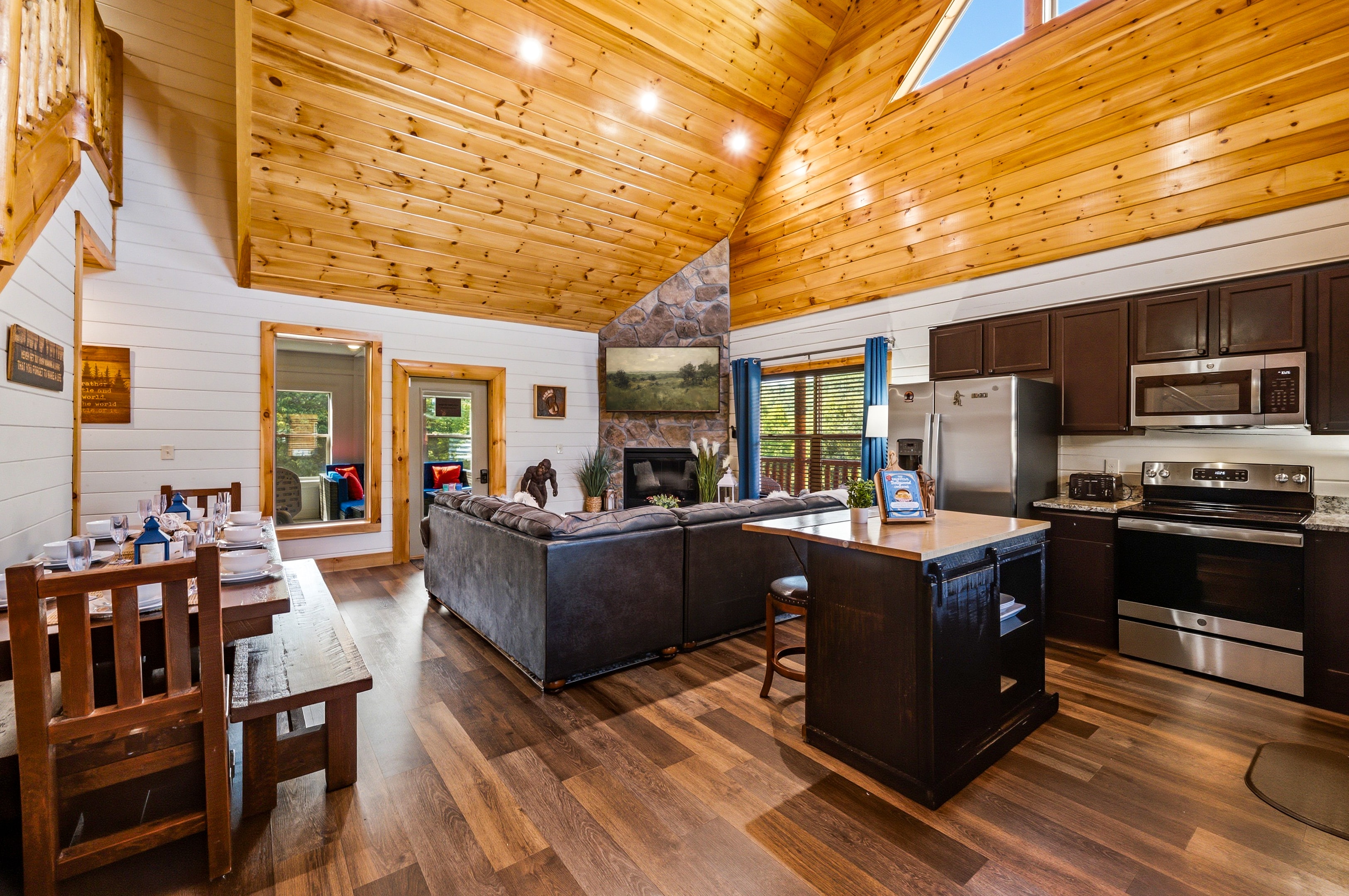 Open living and kitchen area with vaulted wood ceiling