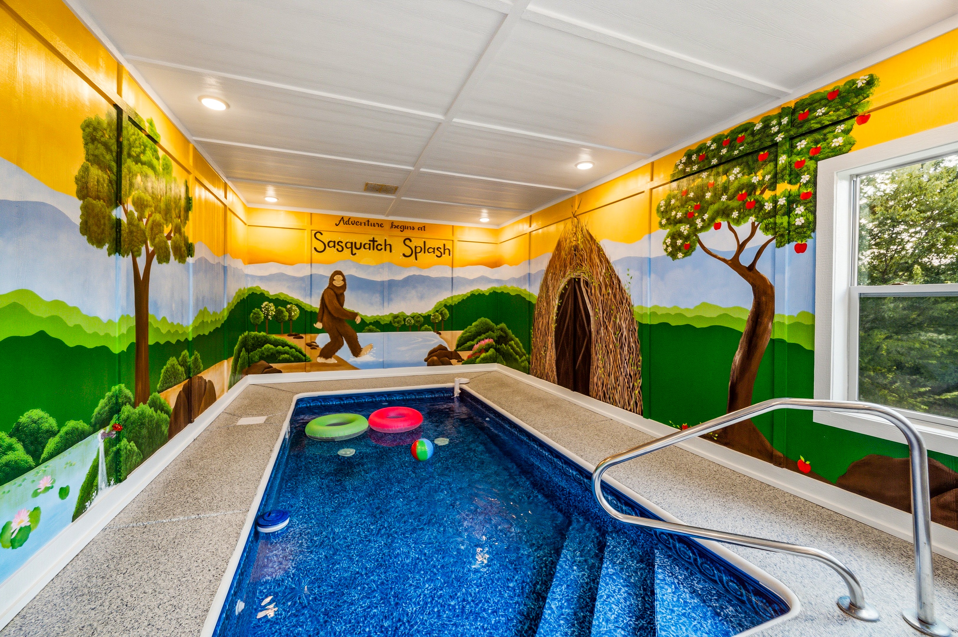 Indoor pool with Adventure begins at Sasquatch Splash mural
